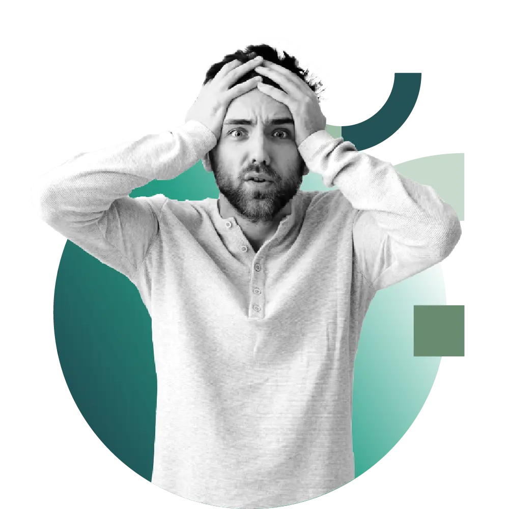 A photo of a worried man with his hands in his hair